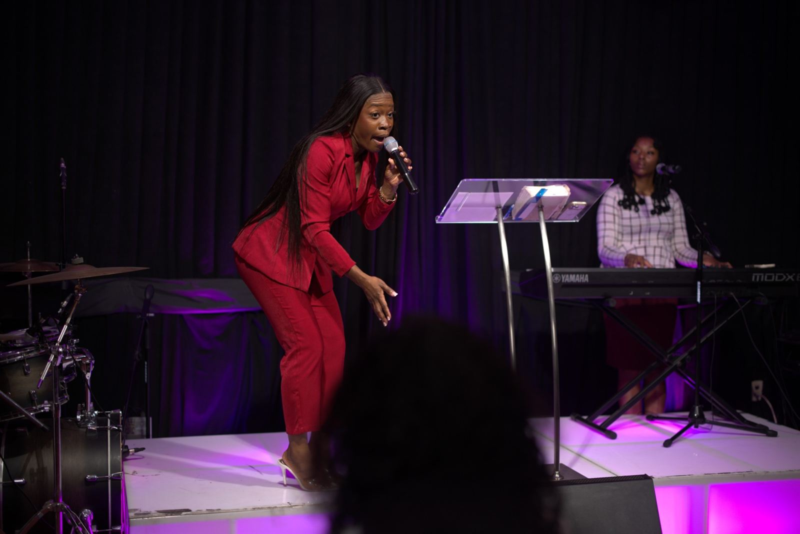 Ink Duncan preaching with a microphone on stage
